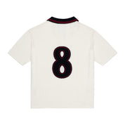 Back view of ParkzBus cream waffle-knit polo shirt with navy and burgundy collar, featuring a large embroidered number 8 in black with burgundy outline